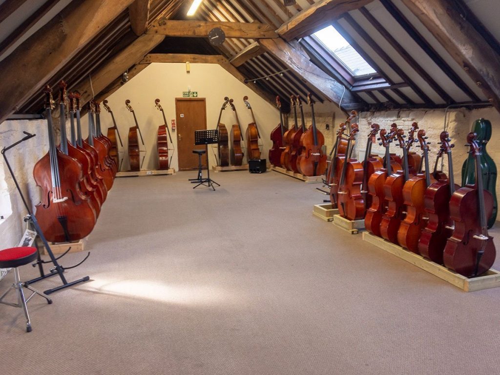 Instrument Showroom with double basses, cellos, violas and violins