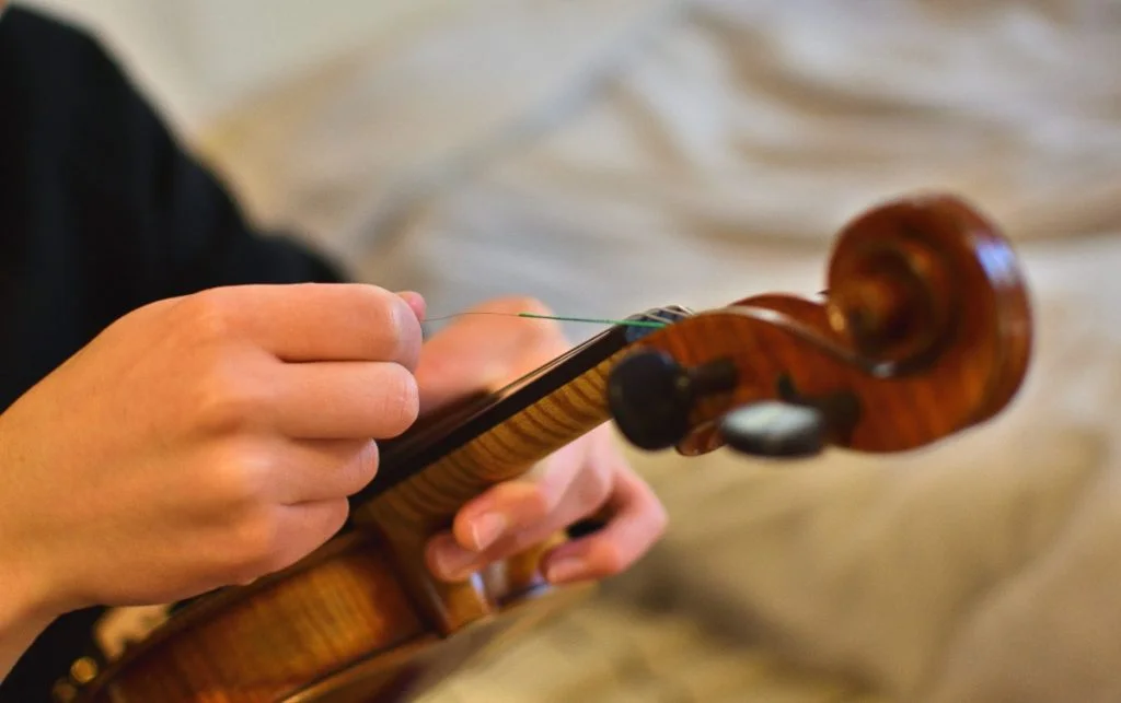 Changing the strings on a violin
